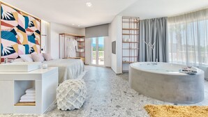 A modern bathroom with a freestanding bathtub, a vanity with a sink, and a large mirror. - Arkadia Luxury Hotel Apartments (Zakynthos)