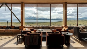 A spacious living area with large windows offering a mountain view.