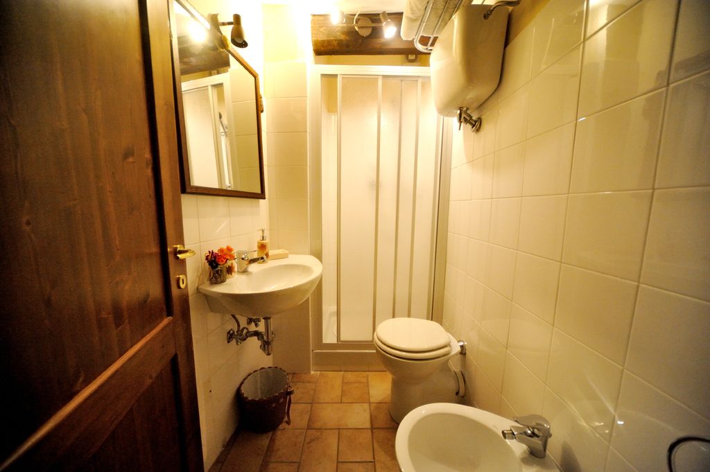 A compact bathroom with a sink, toilet, and bathtub.