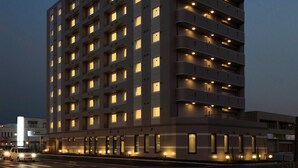 A multi-story hotel with illuminated signage and a modern architectural design. - Hotel Route - Inn Toyota Jinnaka (Toyota)