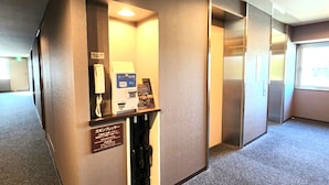 A hotel room with a minibar, a telephone, a card reader, and a coat rack. - Hotel Route-Inn Kameyama Inter (Kameyama)