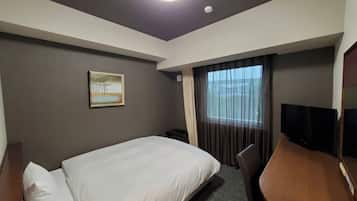 A hotel room with a bed, a desk, a chair, a television, a painting on the wall, and a window with curtains.