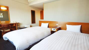 A hotel room with two beds, a desk, a chair, a nightstand, and an air conditioning unit.