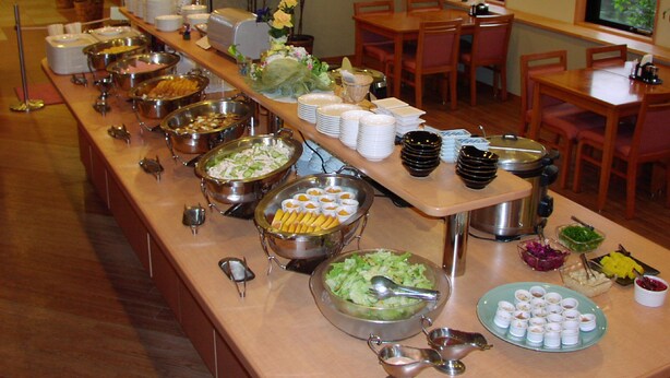 A buffet setup with various food items and serving utensils. - Hotel Route-Inn Yokkaichi (Yokkaichi)