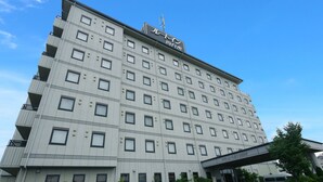 A multi-story hotel with a flat facade, numerous windows, and a covered entrance. - Hotel Route-Inn Yokkaichi (Yokkaichi)