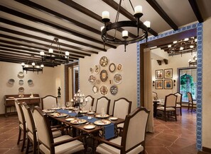 A dining area with a long table set for a meal, surrounded by chairs. - Sawai Man Mahal, Jaipur (Jaipur)