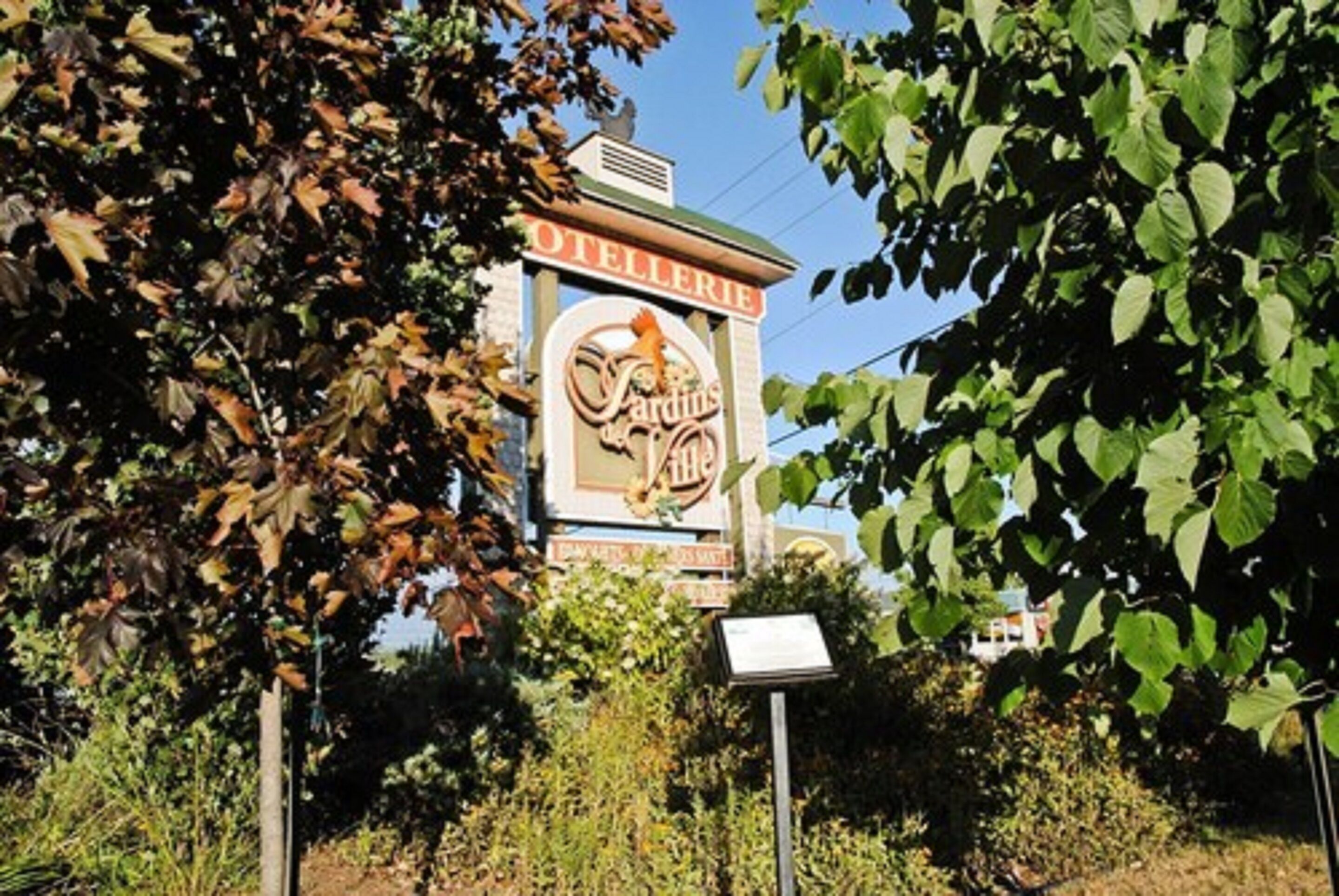Un letrero para una viñedo con un logotipo y la palabra 'VINEYARDS' visible.