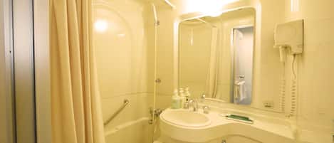 A bathroom with a bathtub, a sink, a toilet, and a mirror.
