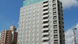 A multi-story hotel with a prominent sign at the top. - Hotel Route Inn Kitakyushu Wakamatsu Ekihigashi (Kitakyushu)