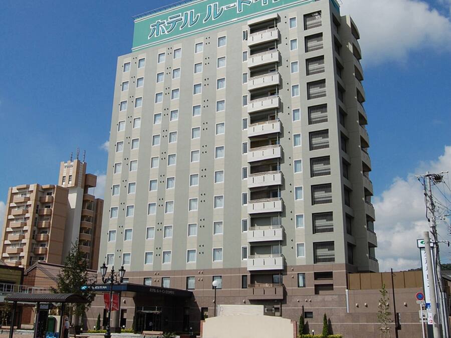 A multi-story hotel with a prominent sign at the top.