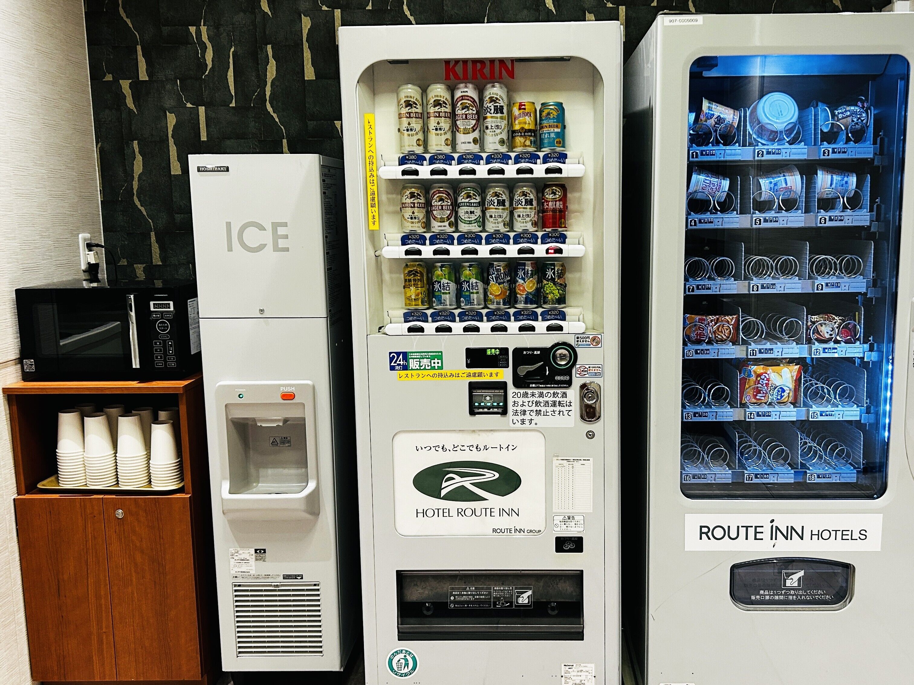 A vending machine with multiple beverage options, a microwave, and a water dispenser.