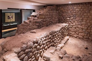 An archaeological exhibit with stone walls and artifacts.