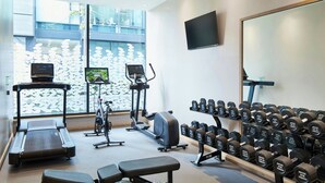 A gym with treadmills, stationary bikes, and a variety of dumbbells. - Residence Inn by Marriott Edinburgh (Edinburgh)