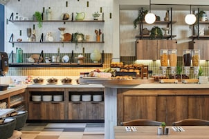 A modern kitchen with wooden cabinets, a central island, and various kitchen utensils and appliances.