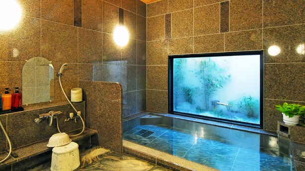 A modern bathroom with a large glass-enclosed hot tub, granite tiles, and a wooden ceiling. - Hotel Route Inn Sagamihara -Kokudo 129 Gou (Sagamihara)