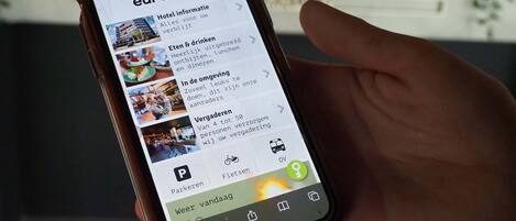 A smartphone displaying the eurohotel website with sections for hotel information, amenities, parking, and a map.