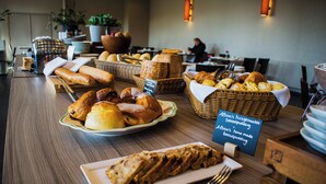 A buffet table with various breads and pastries. - Albion Hotel (Ypres)
