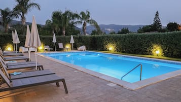 Seasonal outdoor pool, open 9:00 AM to 8:00 PM, pool umbrellas