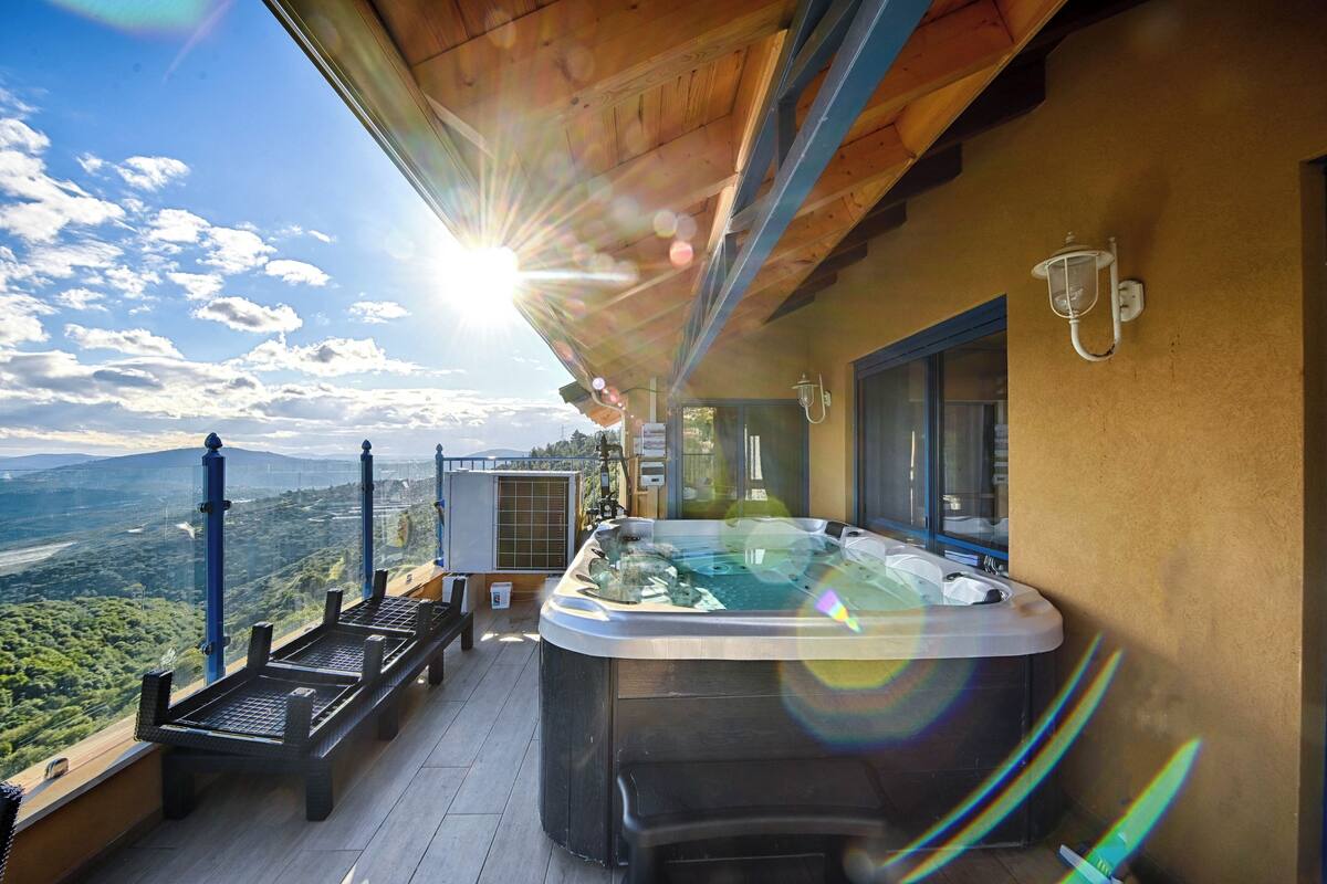 A hot tub on a balcony with a scenic view.