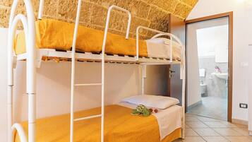 A bunk bed with a yellow mattress and a white headboard.
