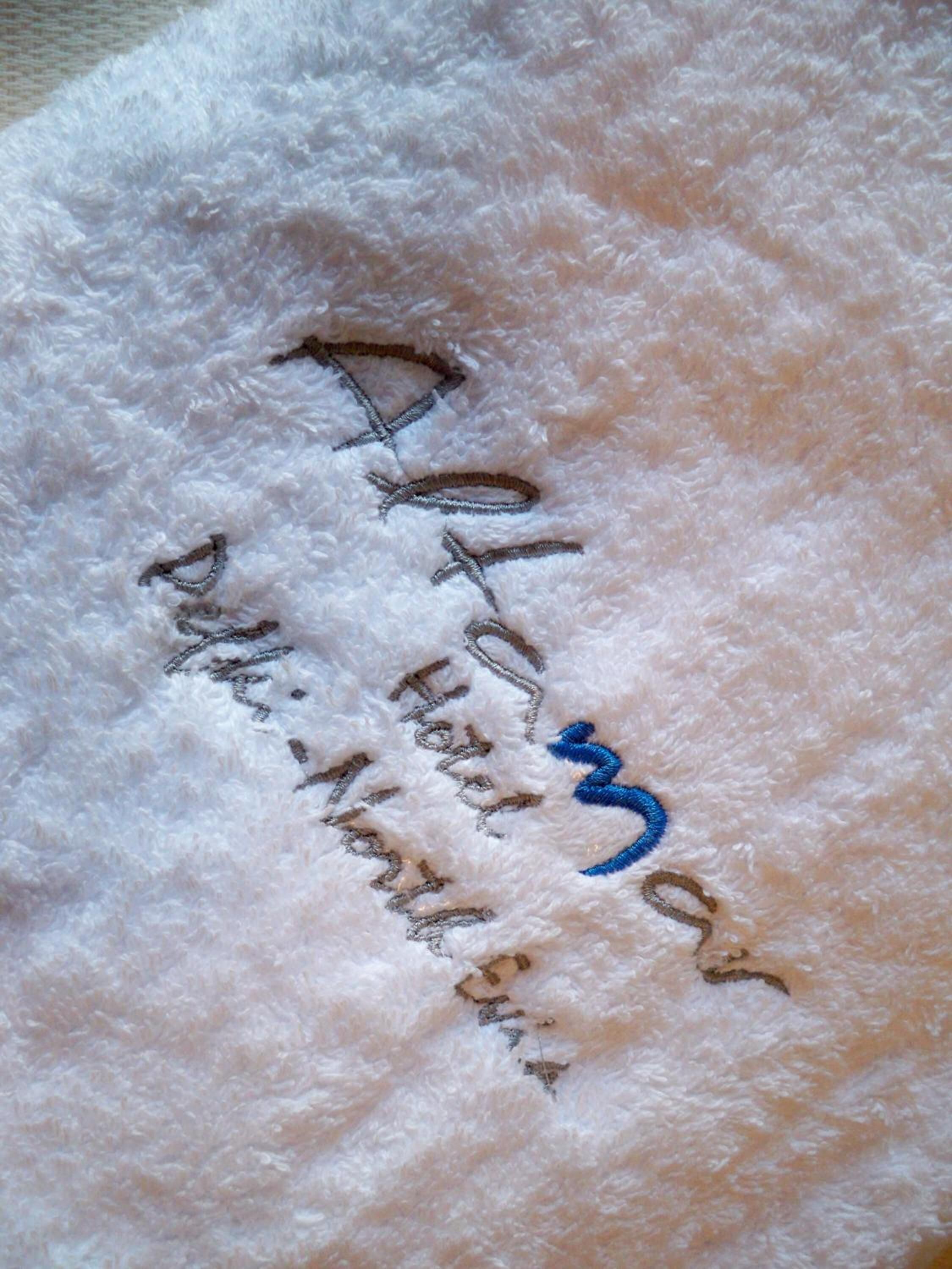 A white, fluffy surface with embroidered text.