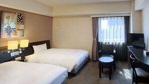 A hotel room with two beds, a desk with a chair, a television, and a painting on the wall.