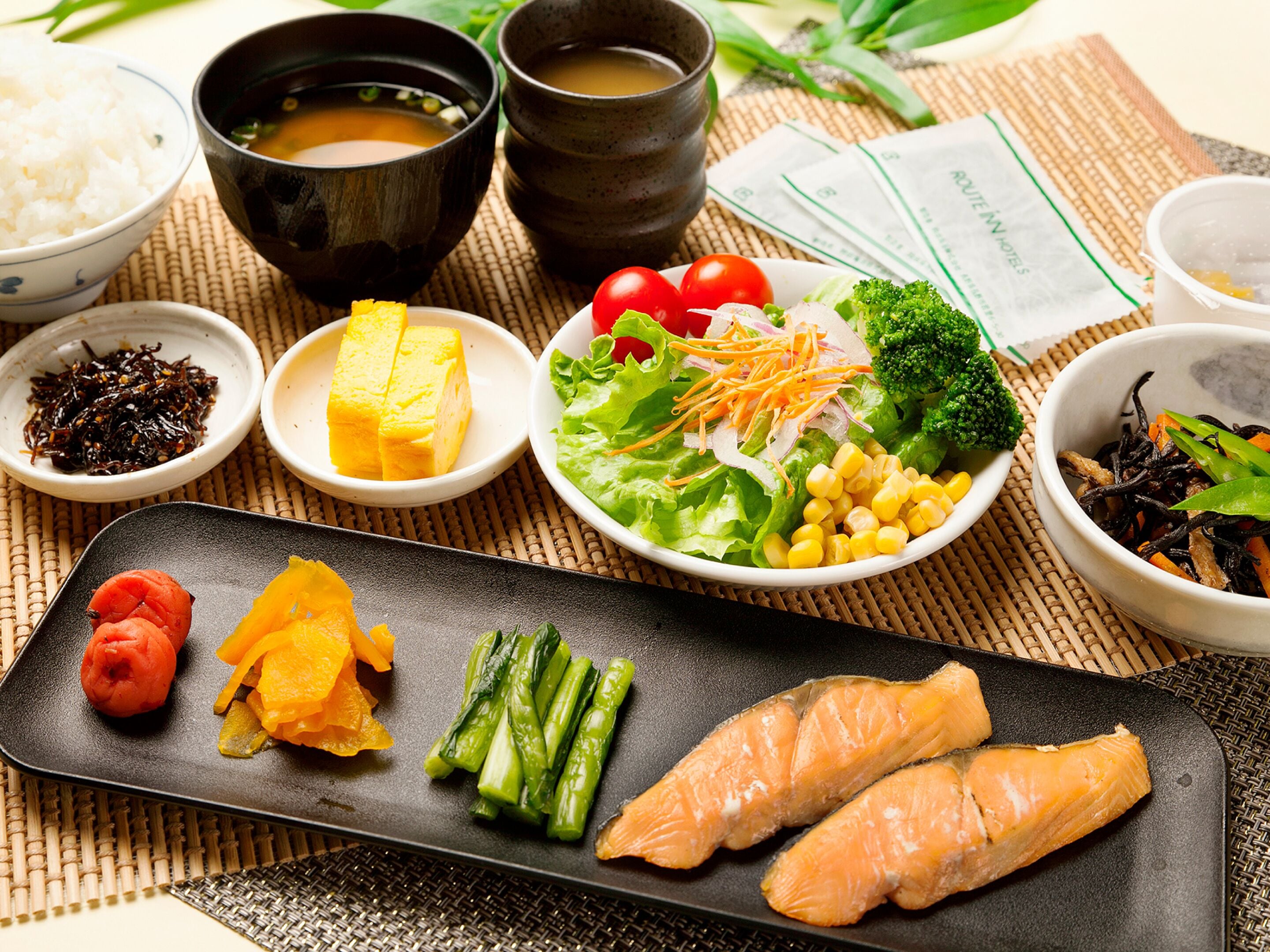 A variety of dishes including salmon, vegetables, and rice, suggesting a meal setting.