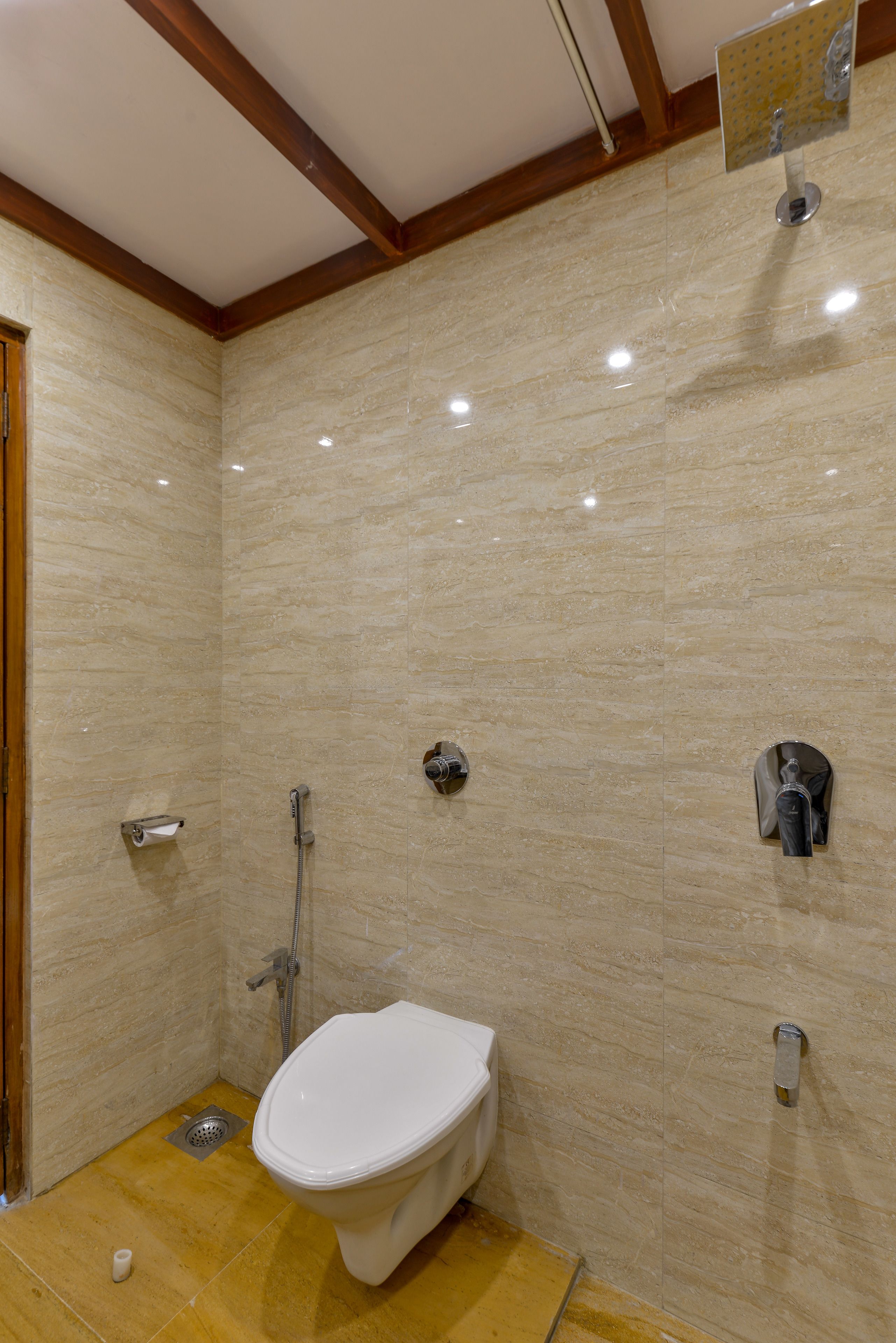 A bathroom with a toilet, shower, and sink.