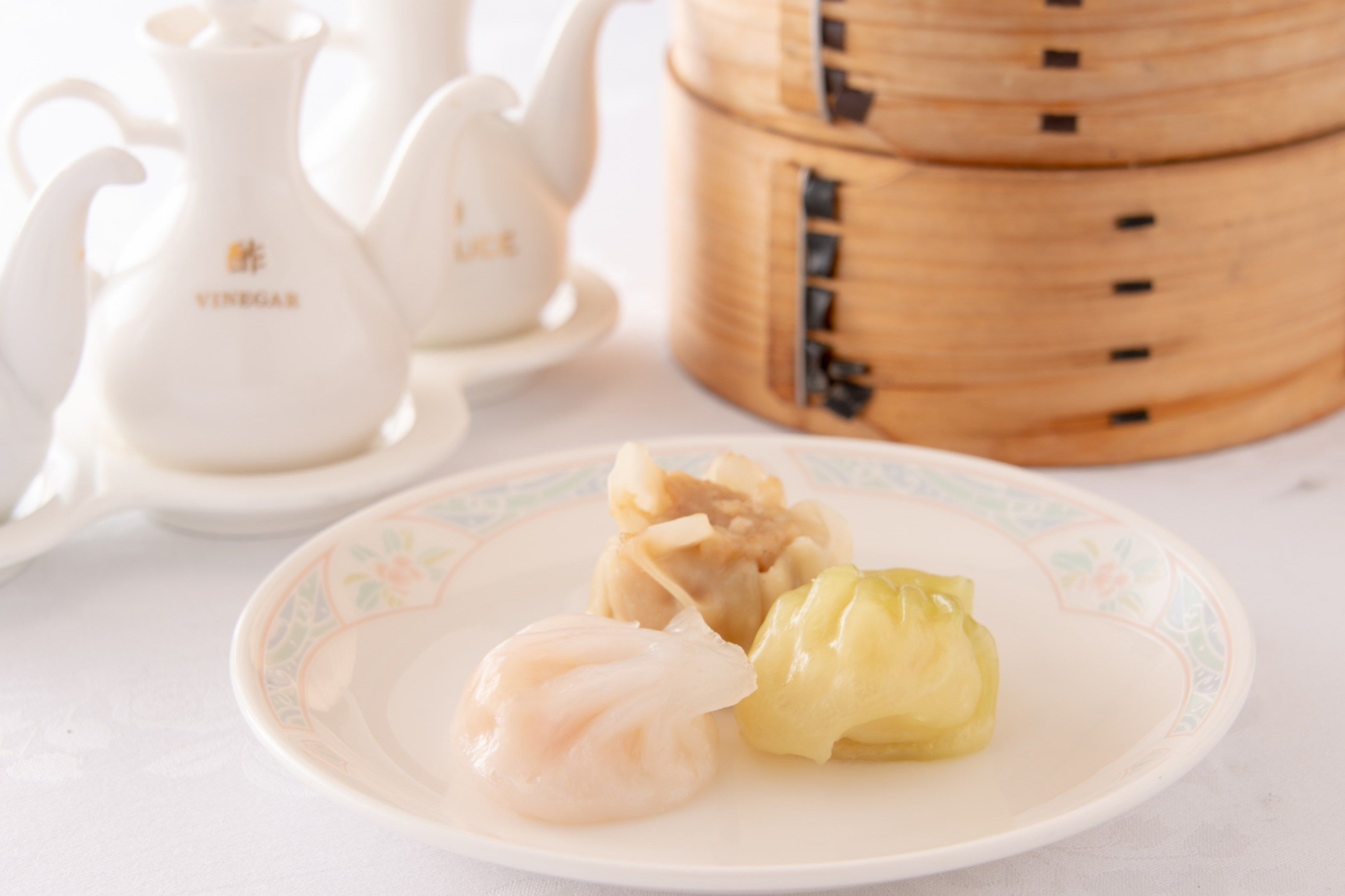 A plate with dumplings and a teapot.