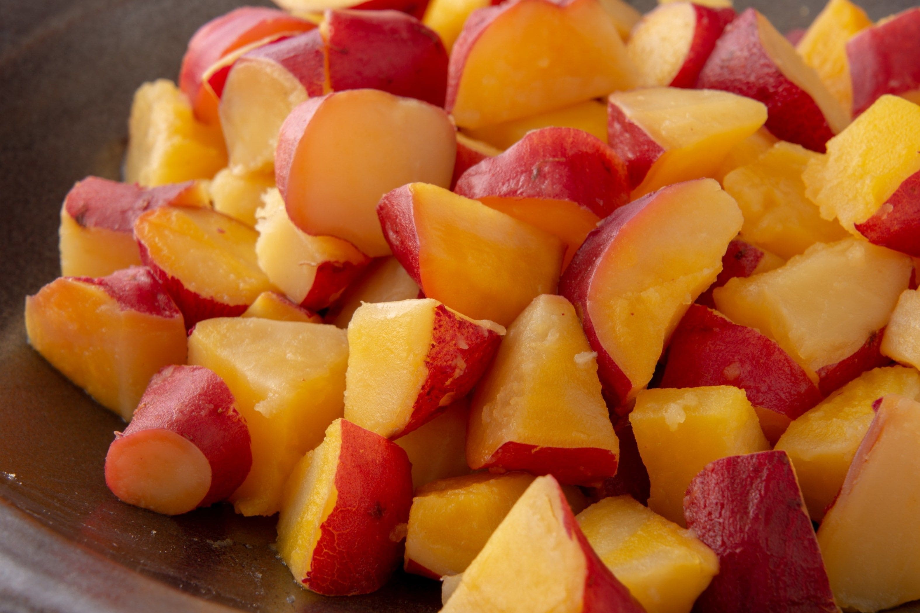 A bowl of diced red and yellow apples.