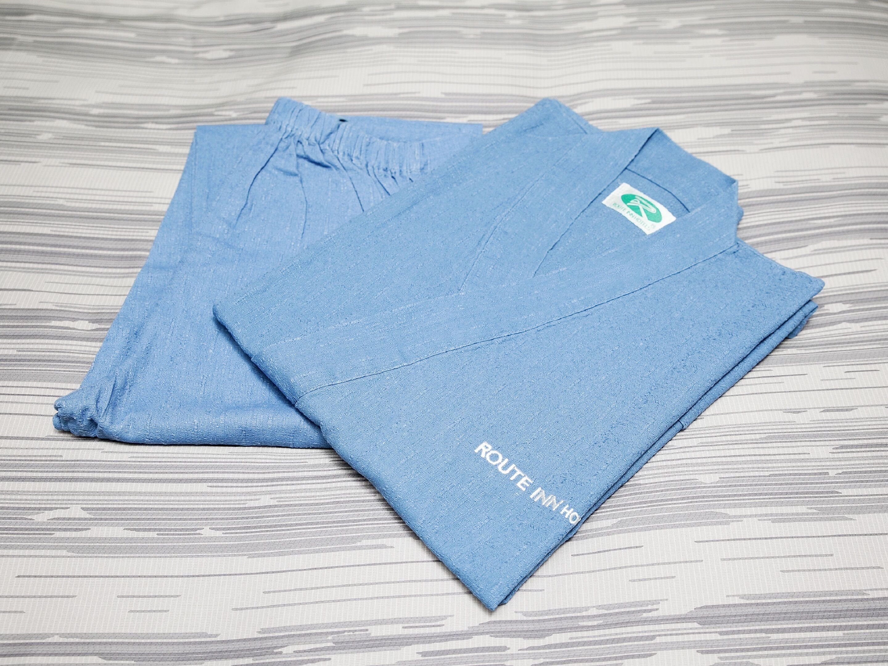 Two folded blue towels with a logo and text on them.