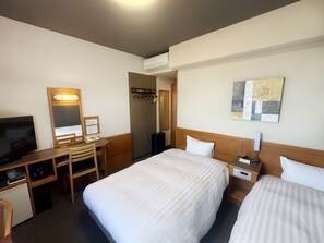 A hotel room with two beds, a desk with a chair, a television, a coat rack, and a painting on the wall.