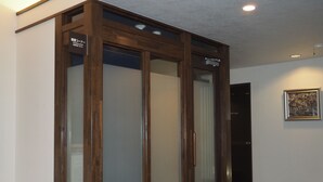 A room with a wooden cabinet, a framed picture on the wall, and a door labeled "STAFF ONLY". - Hotel Route-Inn Court Matsumoto Inter (Matsumoto)