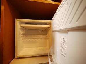 An open refrigerator with a label on the door. - Hotel Route-Inn Court Uenohara (Uenohara)
