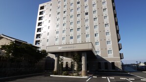 A modern hotel building with multiple floors and a prominent sign indicating it is a hotel.