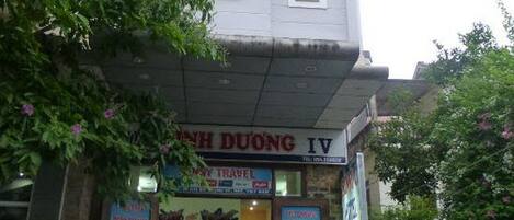A building with a sign reading "HINH DUONG IV" and "TRAVEL".