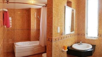 Separate bathtub and shower, designer toiletries, hair dryer, slippers
