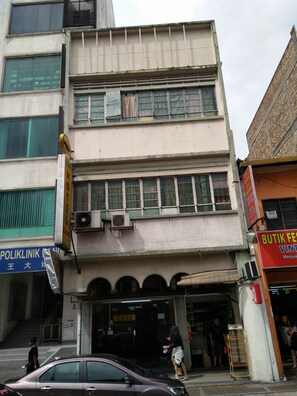 A multi-story building with a sign for a hotel on the ground floor. - Zass Hotel (Kuala Lumpur)
