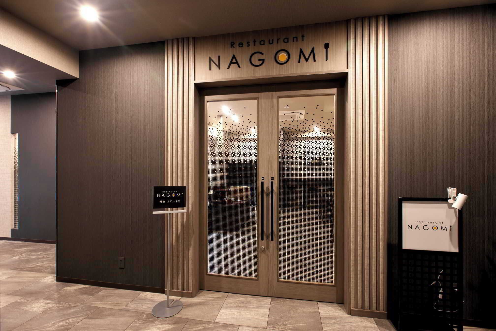 A restaurant entrance with a modern design, featuring a wooden facade and a glass door with a patterned design.