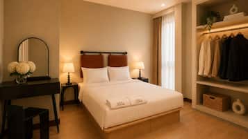 A hotel room with a bed, bedside tables, a mirror, a desk, and a wardrobe.
