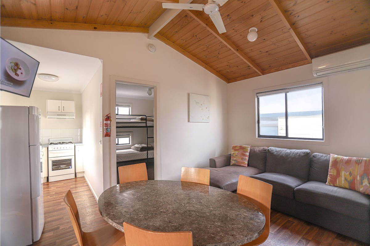 A compact living space with a kitchen, dining area, and seating area.