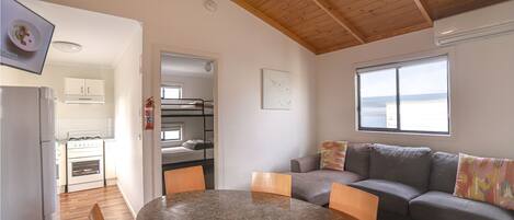 A compact living space with a kitchen, dining area, and seating area.