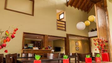 A reception area with wooden furniture, a reception desk, and a large window.