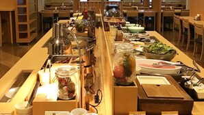 A buffet setup with various food items and condiments. - Hotel Route-Inn Shin Gotenba Inter (Gotemba)