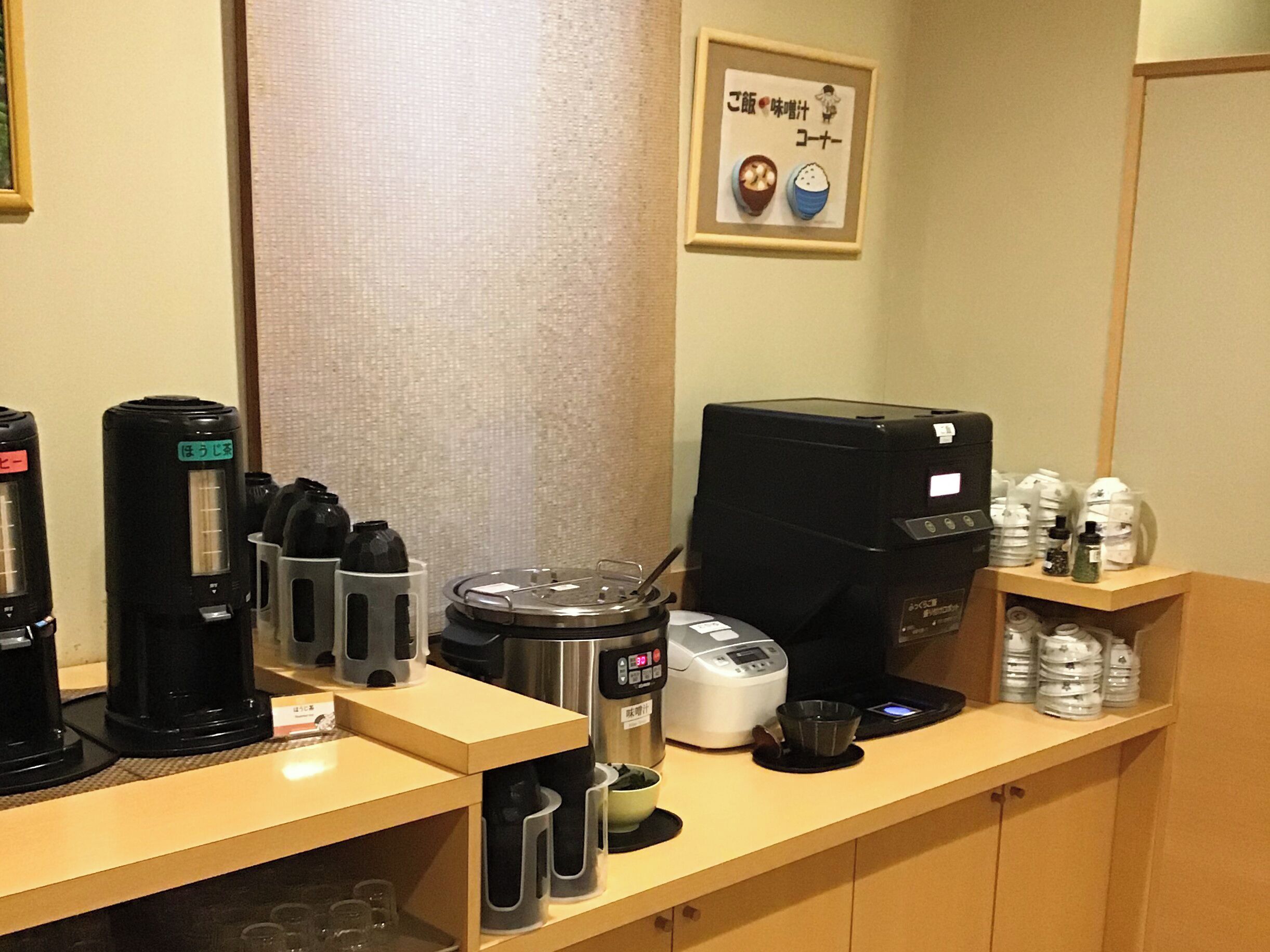 A coffee station with various coffee makers and a coffee machine.