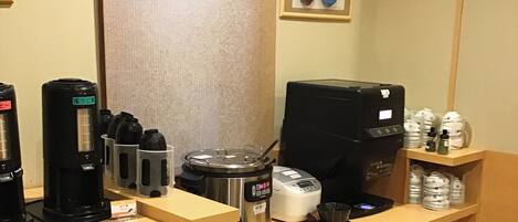 A coffee station with various coffee makers and a coffee machine.