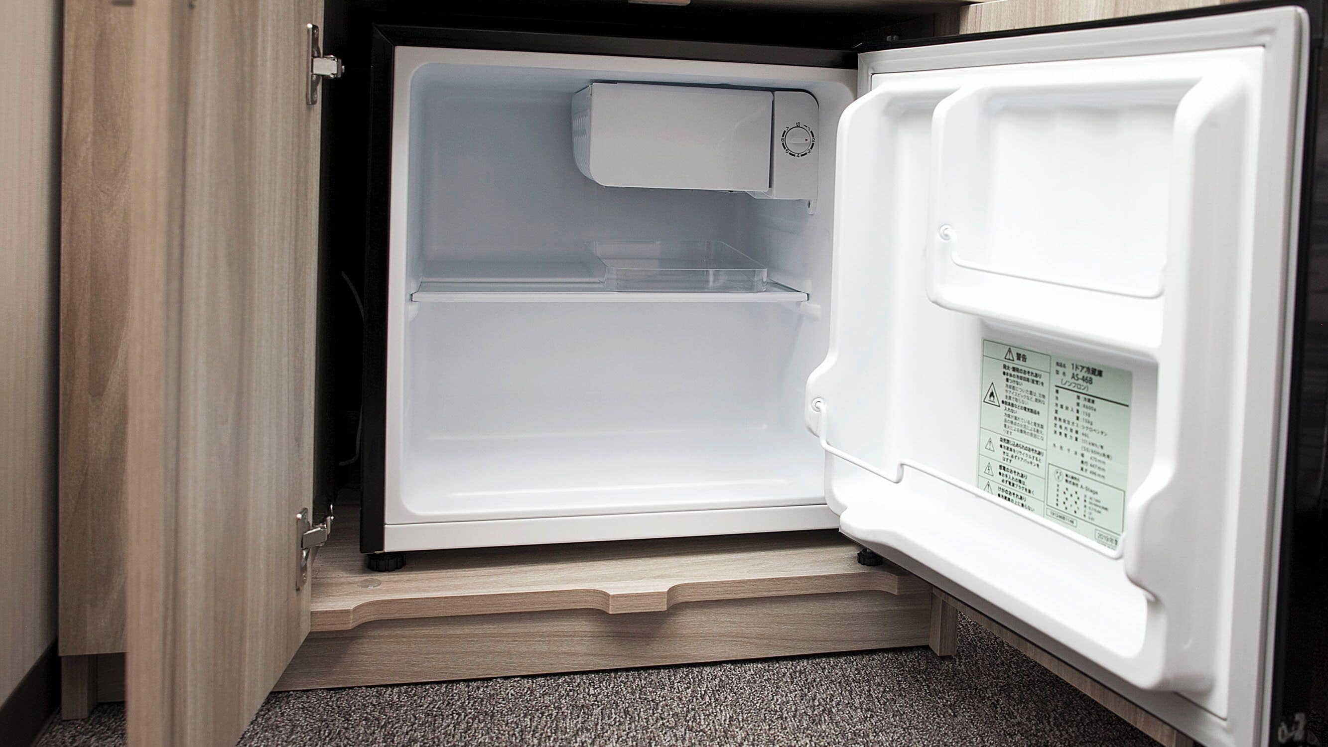 An open refrigerator with a control panel on the right door.