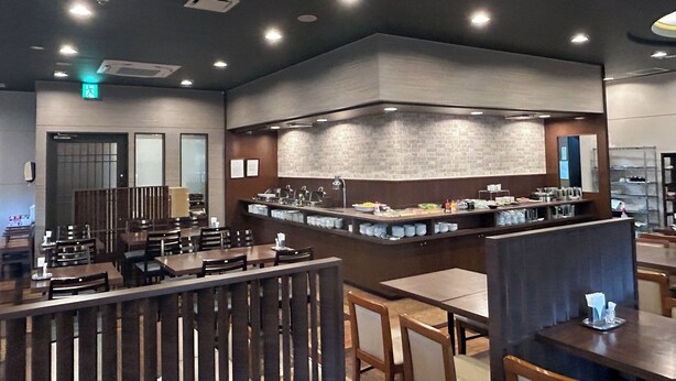 A restaurant with a bar area, seating arrangements, and a modern interior design. - Hotel Route Inn Iwata Inter (Iwata)
