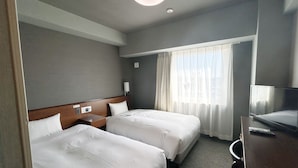 A hotel room with two beds, a desk, a television, and a window with curtains. - Hotel Route Inn Iwata Inter (Iwata)