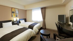 A hotel room with two beds, a desk, a chair, a television, and a painting on the wall.